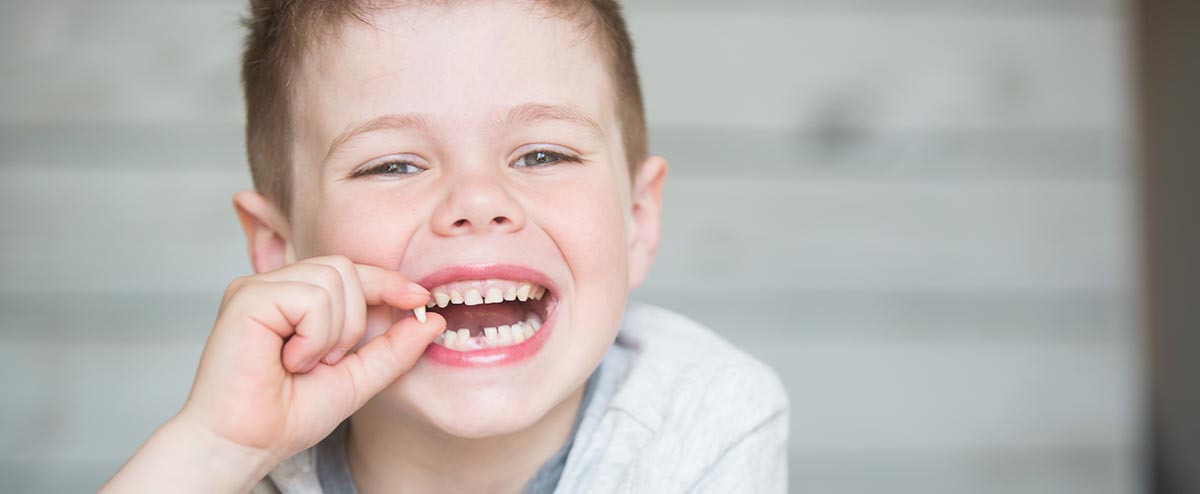 little boy with lost tooth