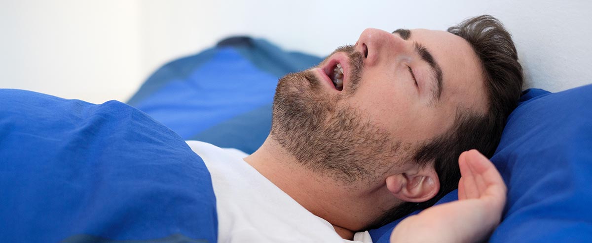man snoring with open mouth
